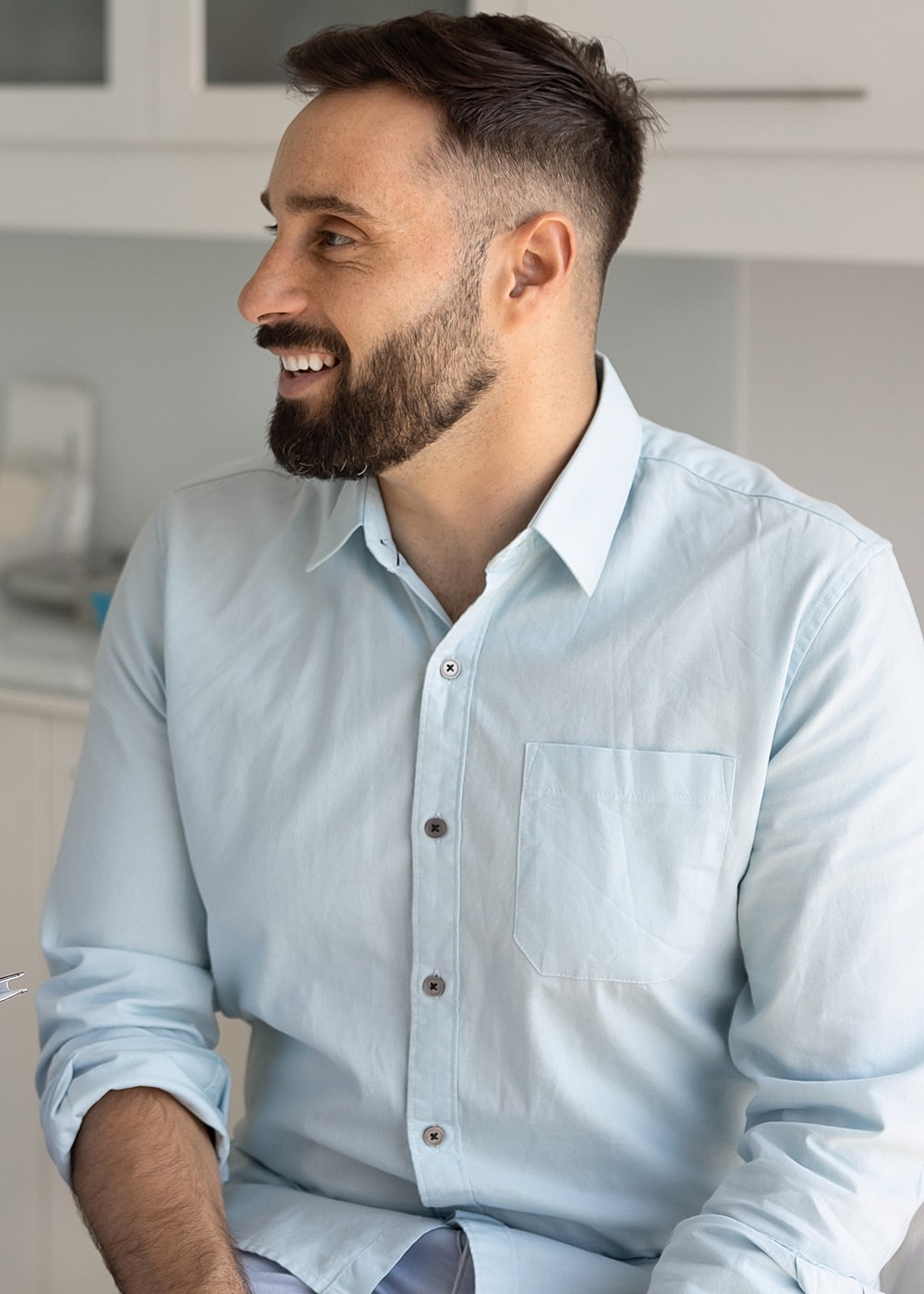 NYC advanced minimally invasive surgery model smiling in a light blue button-up shirt.