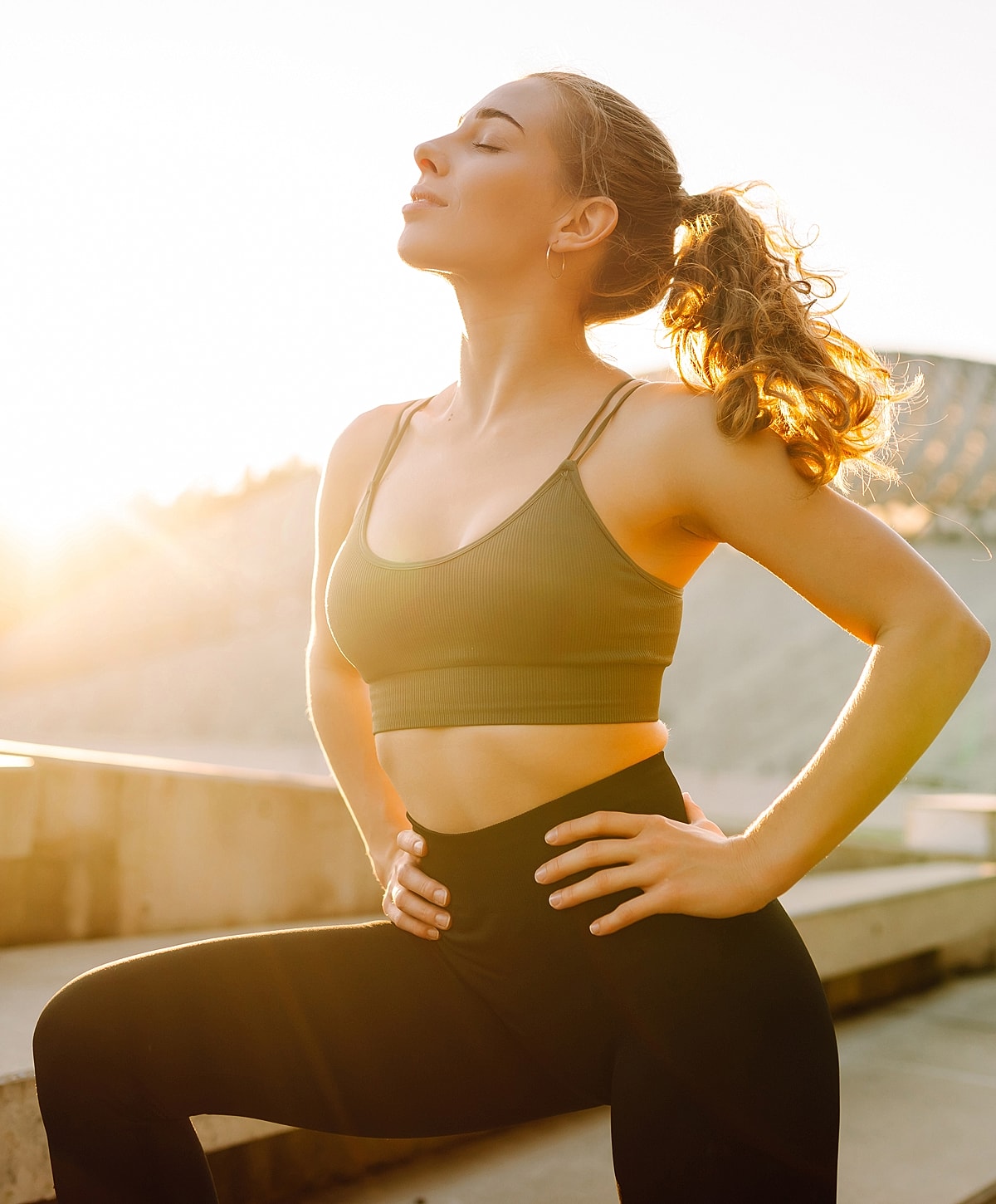 NYC ventrial hernia repair woman practicing yoga in bright sunlight.