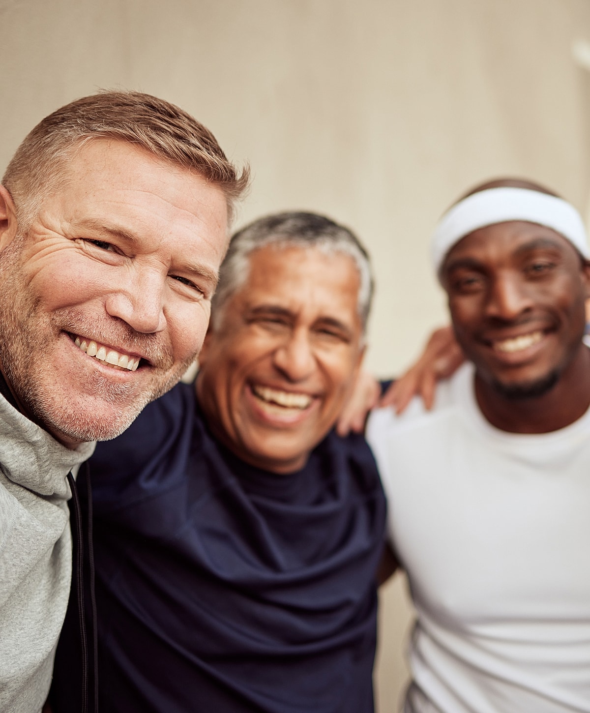 Three smiling men posing together happily after NYC ventrial hernia repair.
