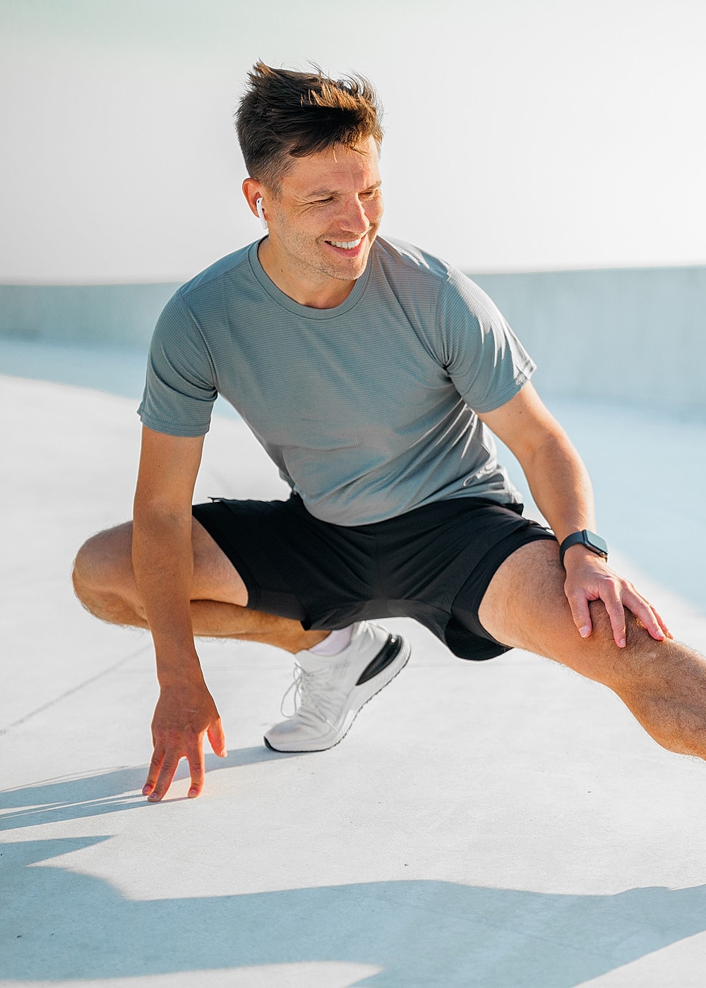 NYC advanced minimally invasive surgery model exercising outdoors with wireless earbuds.